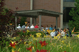 A summer session class enjoys class outside.