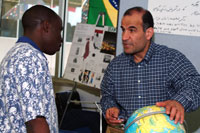 Man showing student globe