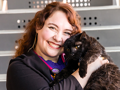  ISU Veterinary Medicine student snuggling a black cat